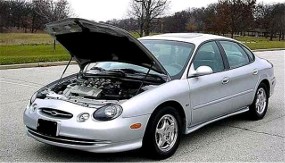 1998 Ford Taurus - Silver 1998 Ford Taurus sedan parked outdoors with the hood open, revealing the engine compartment.