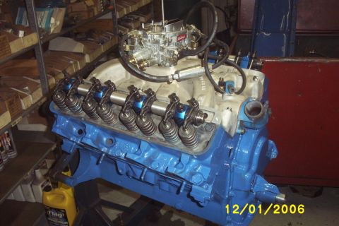 1967 Ford Galaxie - A blue Ford FE engine with an Edelbrock carburetor and visible rocker arms is shown in a workshop setting.