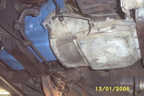1967 Ford Galaxie - Close-up of vehicle undercarriage showing transmission and engine block assembly.