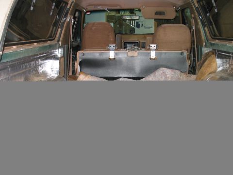 1989 Ford Bronco - Interior view of a 1989 Ford Bronco, showing brown seats and insulation in the cargo area.