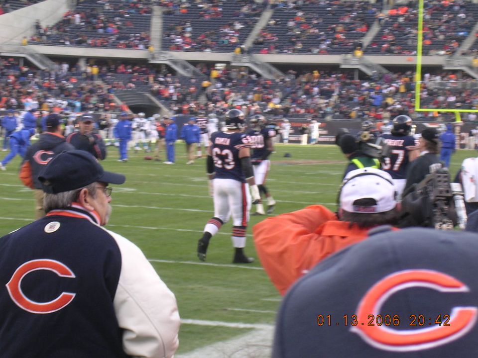 Football players on a field with spectators in the stands