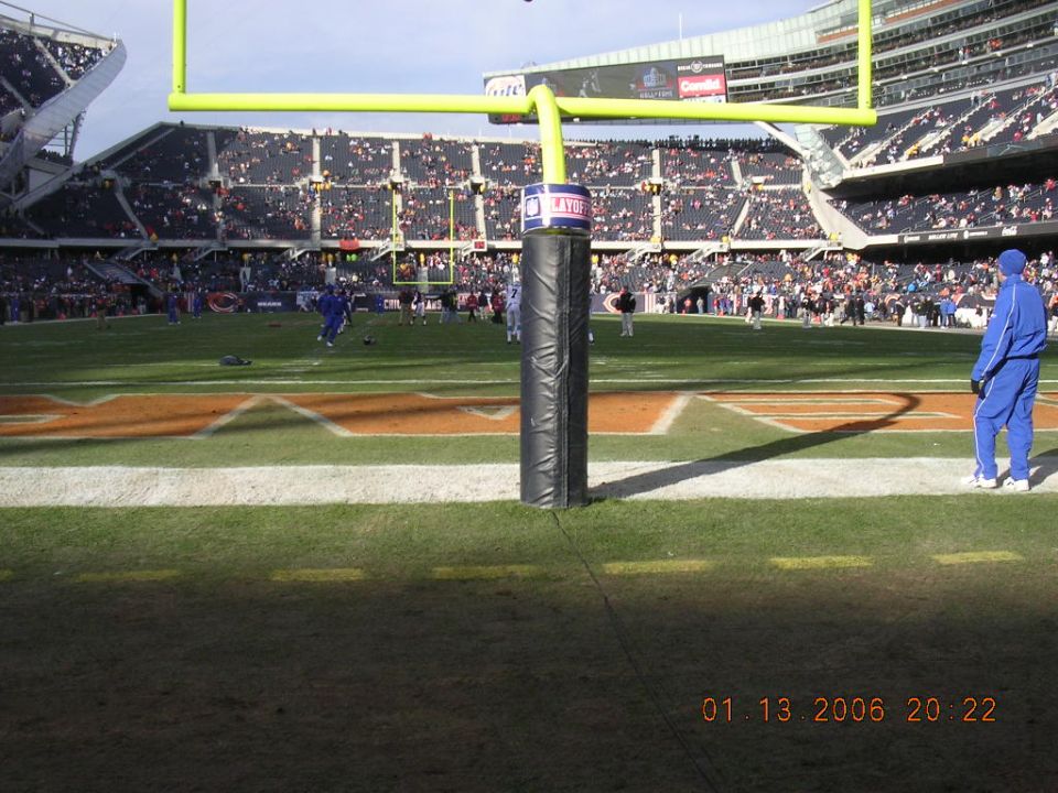 Football stadium with goalposts and spectators, timestamp 01.13.2006 20:22
