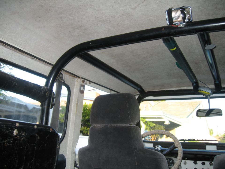 FJ40 interior with black roll bar, gray cloth seat and white headliner