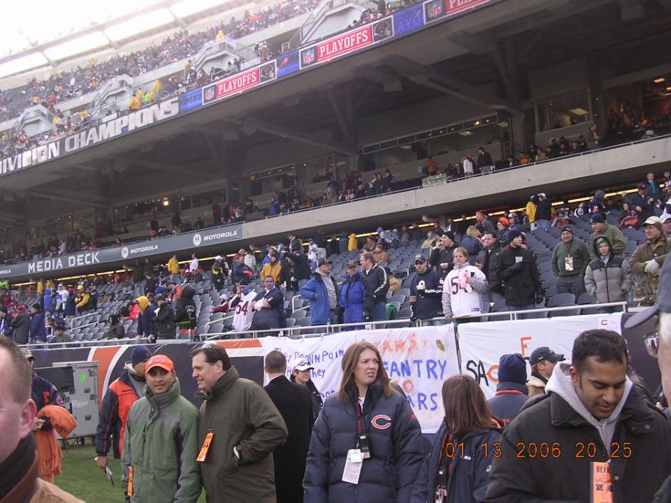 People in stadium seating with playoff banners overhead