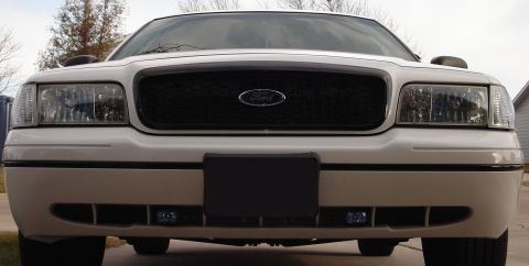 2000 Ford Crown Victoria - Front view of a white 2000 Ford Crown Victoria with a black grille and fog lights.