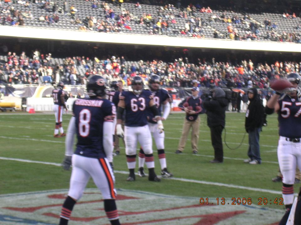 Football players in uniform on a field with a crowd in the background. A date stamp reads 01.13.2008