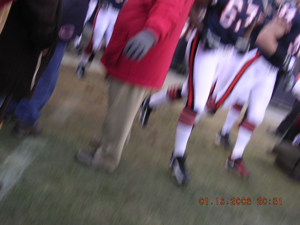 People in football uniforms on a field, timestamp 01.13.2006