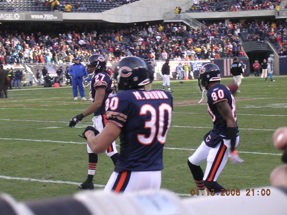 Football players on a field with spectators in the background