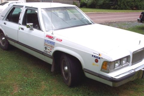1988 Mercury Grand Marquis - This white sedan is covered in racing decals, suggesting a past life on the track.