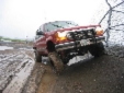 1991 Ford Explorer - 1991 Ford Explorer navigating a muddy, snowy terrain.