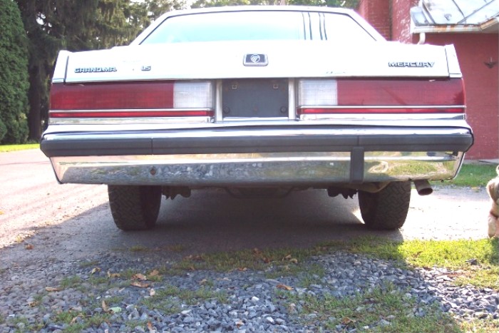Rear view of a white 1988 Mercury Grand Marquis with chrome bumper and taillights