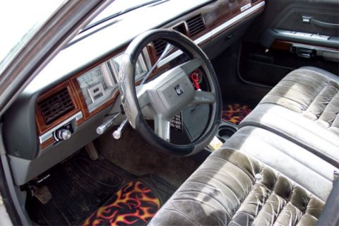 1988 Mercury Grand Marquis - Interior view of a 1988 Mercury Grand Marquis, plush seating and custom floor mats.