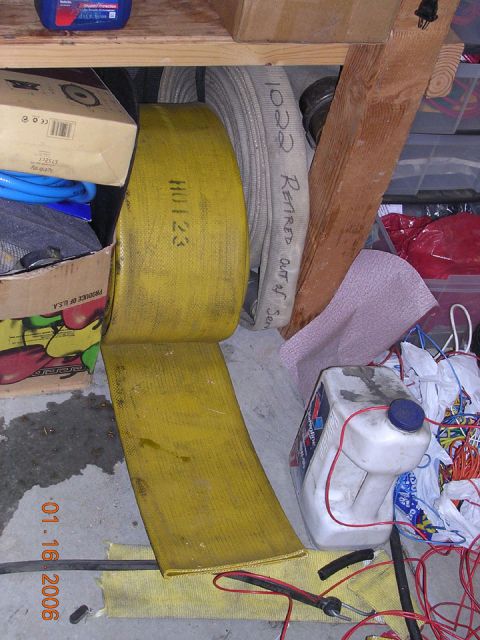 1994 Ford Bronco - Fire hoses labeled 'HU123' and 'Retired Out of Service' are stored with other items.
