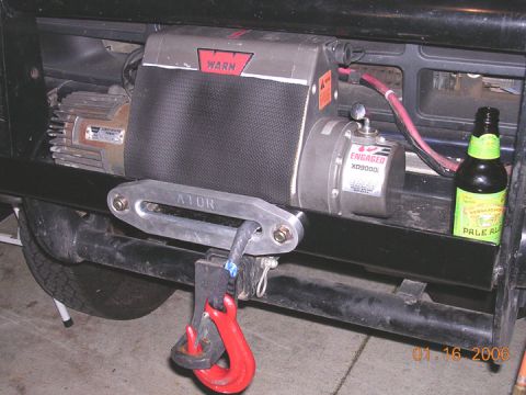 1994 Ford Bronco - Warn XD9000 winch and tow hook assembly, with a bottle of pale ale nearby.