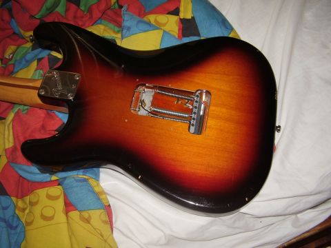 1996 Ford F-150 - The back of a sunburst electric guitar is shown, with its bridge and neck plate visible.