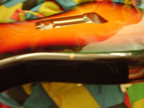 1996 Ford F-150 - The body of an electric guitar with a sunburst finish is visible, with a pickup cavity open.