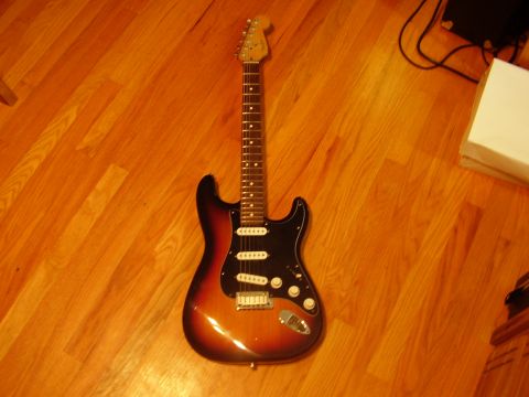 1996 Ford F-150 - An electric guitar lies on a polished wooden floor.