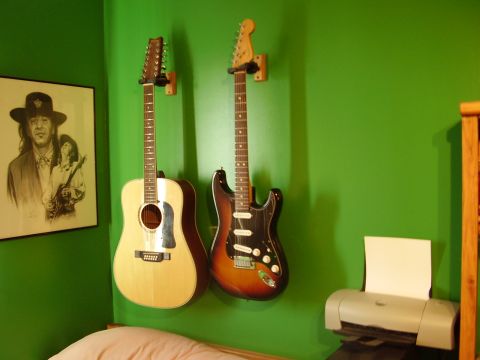 1996 Ford F-150 - Acoustic and electric guitars are mounted on a wall with a portrait and a printer in the room.