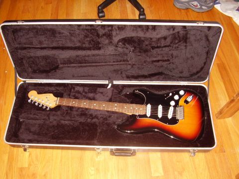 1996 Ford F-150 - An electric guitar with a sunburst finish rests inside its open protective case.