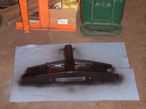 1988 Suzuki Samurai - A black metal part, possibly a bumper or winch mount, is shown on a blue paper towel.
