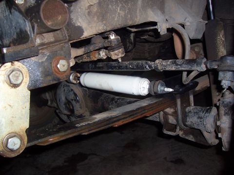 1988 Suzuki Samurai - Close-up view of the front suspension and steering linkage of an off-road vehicle.
