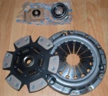 1996 Ford Probe - A clutch kit, including a pressure plate and disc, is laid out on a wooden floor.