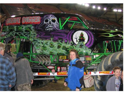 1976 Ford F-150 - The Grave Digger monster truck is displayed with custom artwork and a crowd.