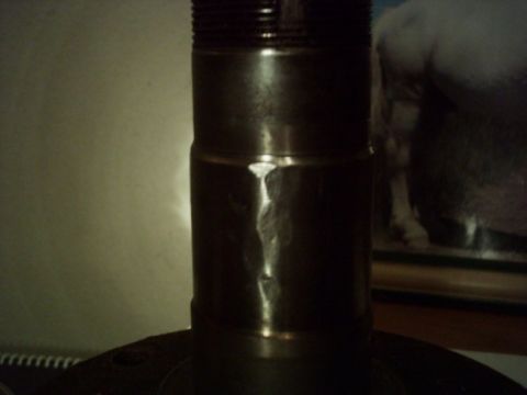 1986 Ford Bronco - This metal part has a threaded top and a distinct seam running down its side.