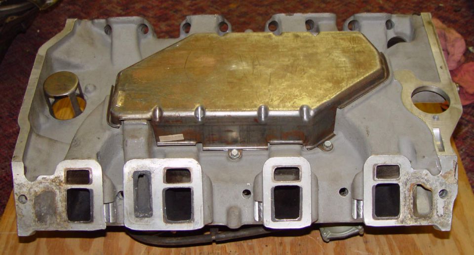 Aluminum intake manifold with a gold-colored cover plate