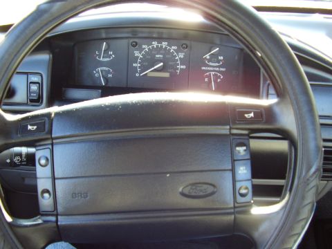 1996 Ford F-150 - Ford truck dashboard showing speedometer, fuel and temperature gauges behind the steering wheel with SRS airbag pad.