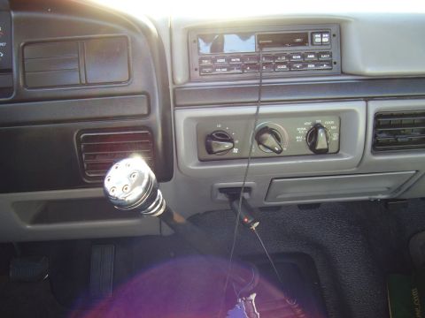 1996 Ford F-150 - The interior of a truck features a chrome gear shifter and the dashboard controls.