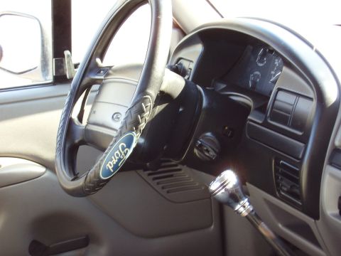 1996 Ford F-150 - The interior of a Ford truck, a steering wheel with a Ford logo and a chrome gear shift knob.