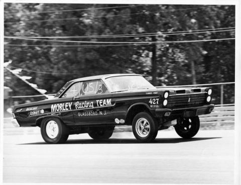 1963 Ford Fairlane - A Mercury Comet drag car with '427 WEDGE' on the front fender races down a track.