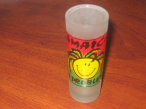 1991 Ford Bronco - A frosted shot glass features a red band with "Jamaica" and a yellow smiley face with dreadlocks.