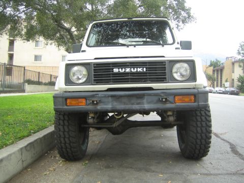 1987 Suzuki Samurai - Frontal view of a 1987 Suzuki Samurai, showing its grille and tires.