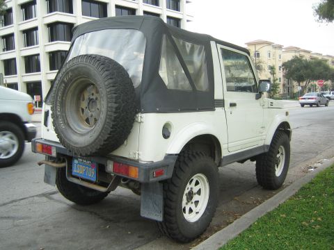 1987 Suzuki Samurai - This 1987 Suzuki Samurai is seen from the rear, its iconic spare tire mounted on the back.