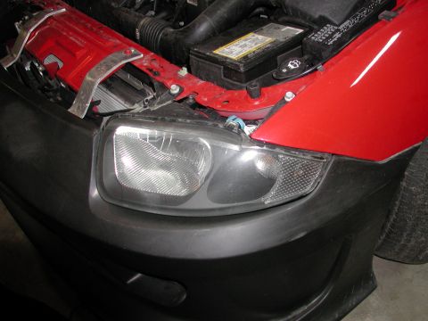 2005 Chevrolet Cavalier - Front headlight assembly and engine components of a vehicle.