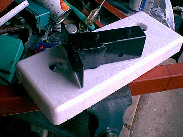 i used a bolt in spacer. this way i can adjust the presure on the flap to stop the rattling. i just drilled and tapped the holes.