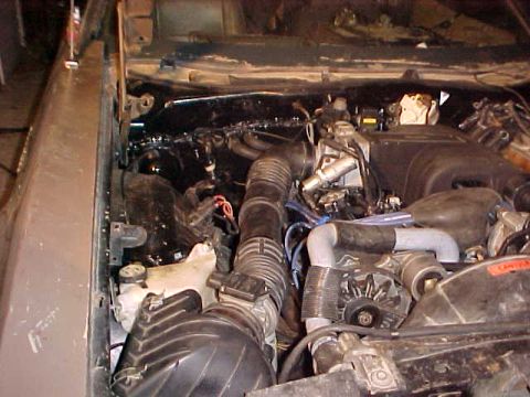 1973 Ford Ranchero - Close-up view of a vehicle's engine compartment, showing various mechanical components and wiring.