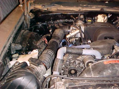 1973 Ford Ranchero - Close-up view of a vehicle's engine bay, showing various components and hoses.