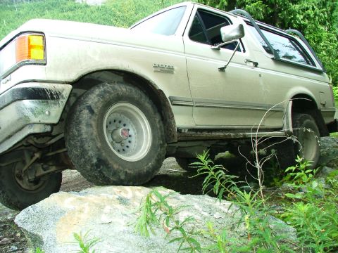 1988 Ford Bronco - This Ford Bronco appears to be from the late 1980s, likely a 1987 model, navigating rough terrain.