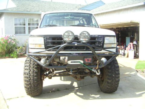 1991 Ford Bronco - This modified Ford Bronco features a winch and bull bar, suggesting it's ready for off-road adventures.