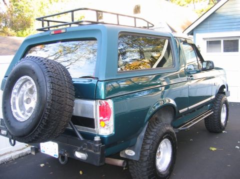 1991 Ford Bronco - This 1991 Ford Bronco has a roof rack and a spare tire mounted on the rear bumper.