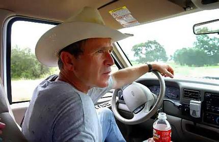 1974 Ford Bronco - Man in cowboy hat driving a truck interior view.