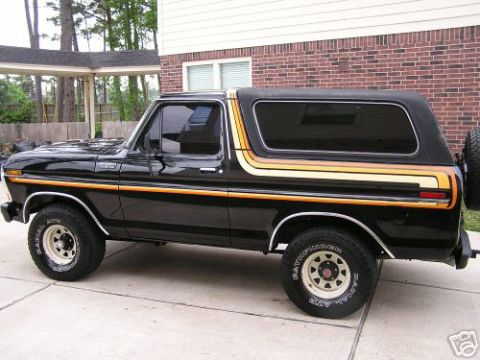 1993 Ford Bronco - This black Ford Bronco features distinctive orange and yellow stripe graphics along its side.