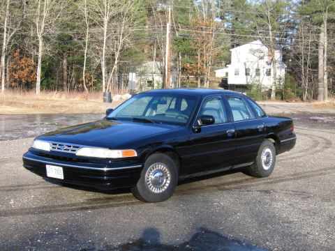 1991 Ford Crown Victoria LTD - This 1991 Ford Crown Victoria LTD is captured in a three-quarter front view, its classic sedan body style.