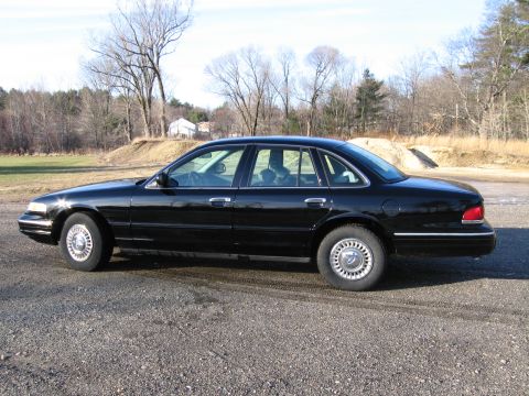 1991 Ford Crown Victoria LTD - This 1991 Ford Crown Victoria LTD is seen from the side in a rural setting.