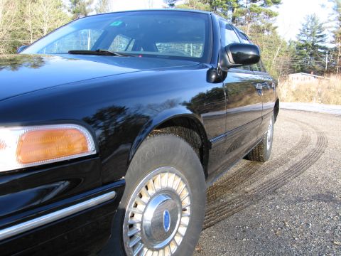 1991 Ford Crown Victoria LTD - Front quarter view of a black 1991 Ford Crown Victoria LTD on a gravel surface.