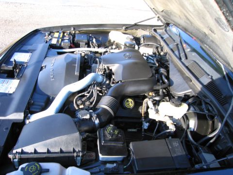 1991 Ford LTD Crown Victoria - The engine bay of a 1991 Ford Crown Victoria LTD is visible with the hood raised.