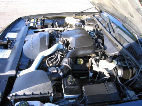 1991 Ford LTD Crown Victoria - The engine bay of a vehicle is shown with various components visible, including the air intake system and engine cover.